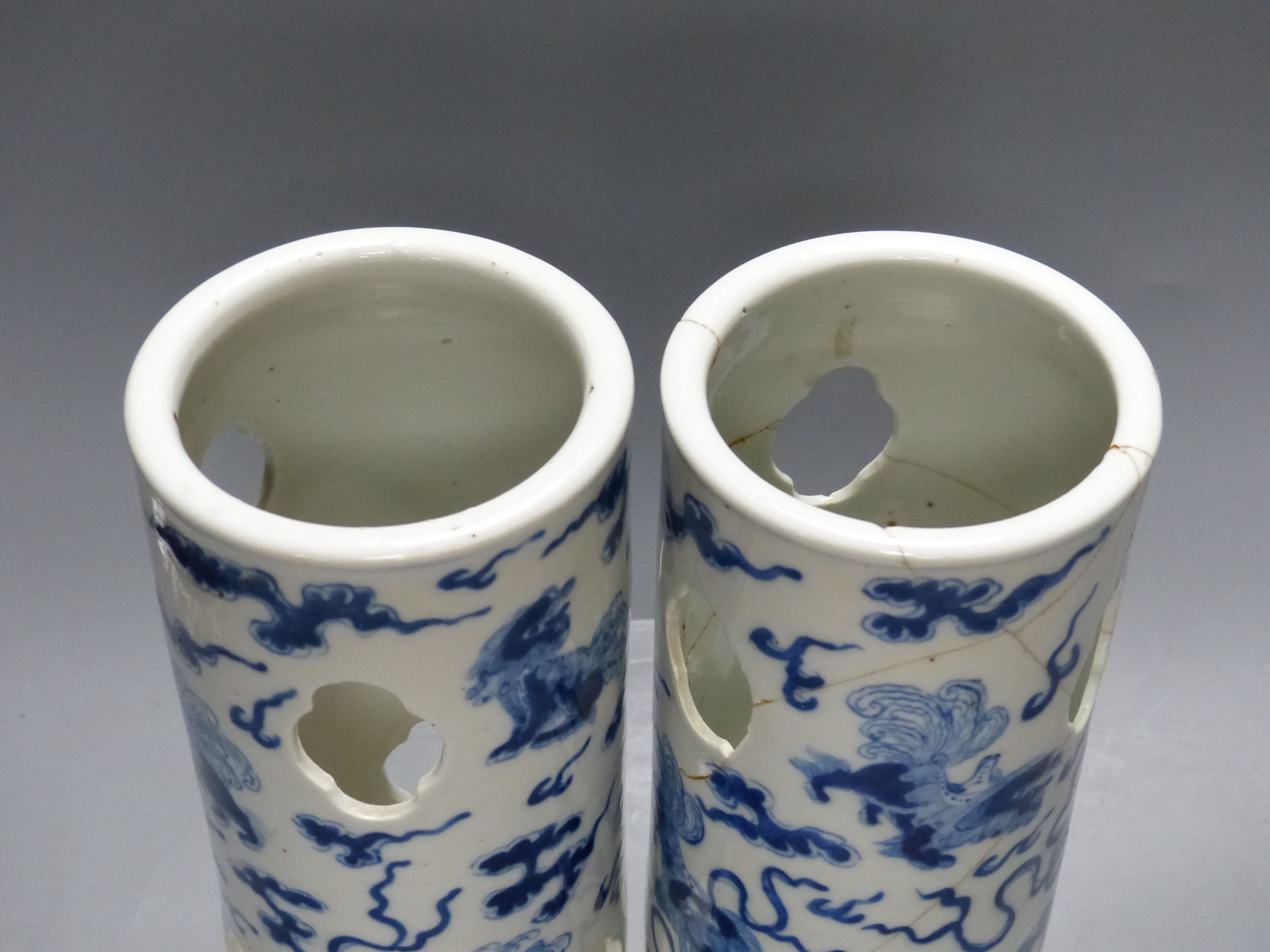 A pair of early 20th century Chinese blue and white hat stands, Kangxi marks, 29cm high